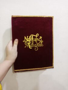 Maroon velvet Nikkah Mubarak booklet cover with gold lettering